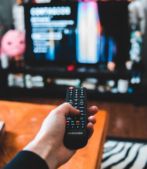 person holding black remote control