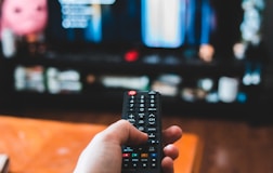 person holding black remote control