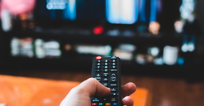 person holding black remote control