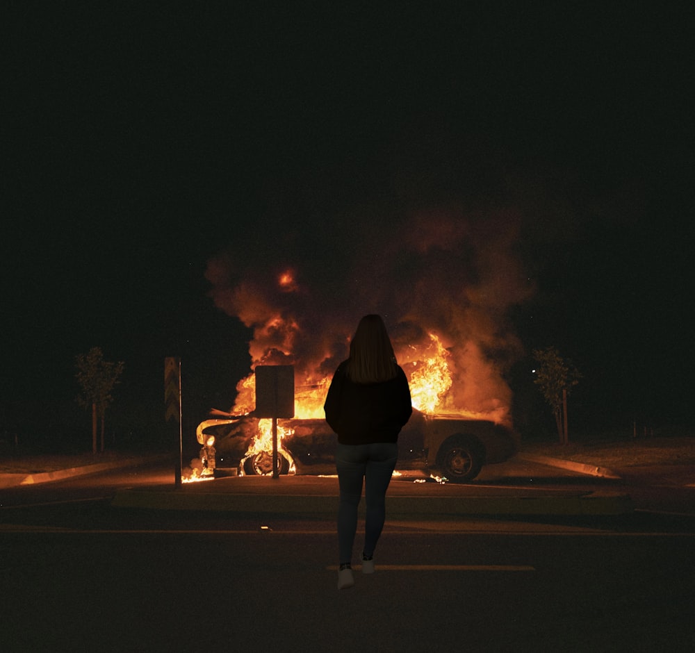 man and woman standing on road during night time