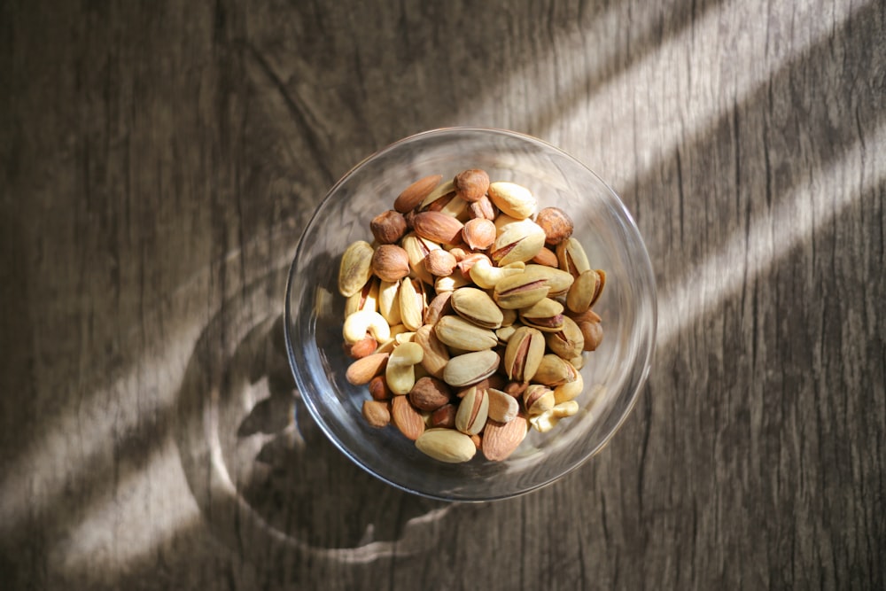 brown peanuts in clear glass bowl