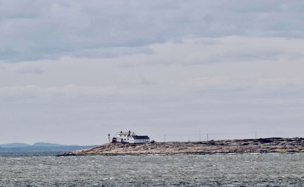 white and black boat on sea under white sky during daytime