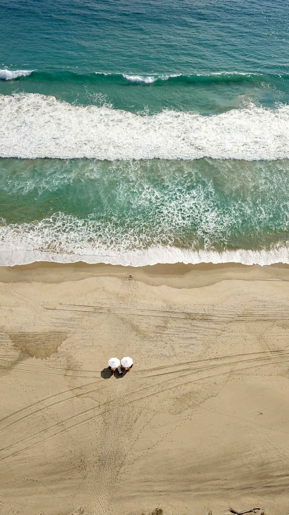 white and black soccer ball on beach during daytime