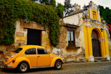 a yellow car parked in front of a building