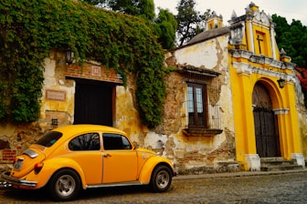 a yellow car parked in front of a building