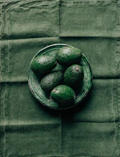 black round fruits in clear glass bowl