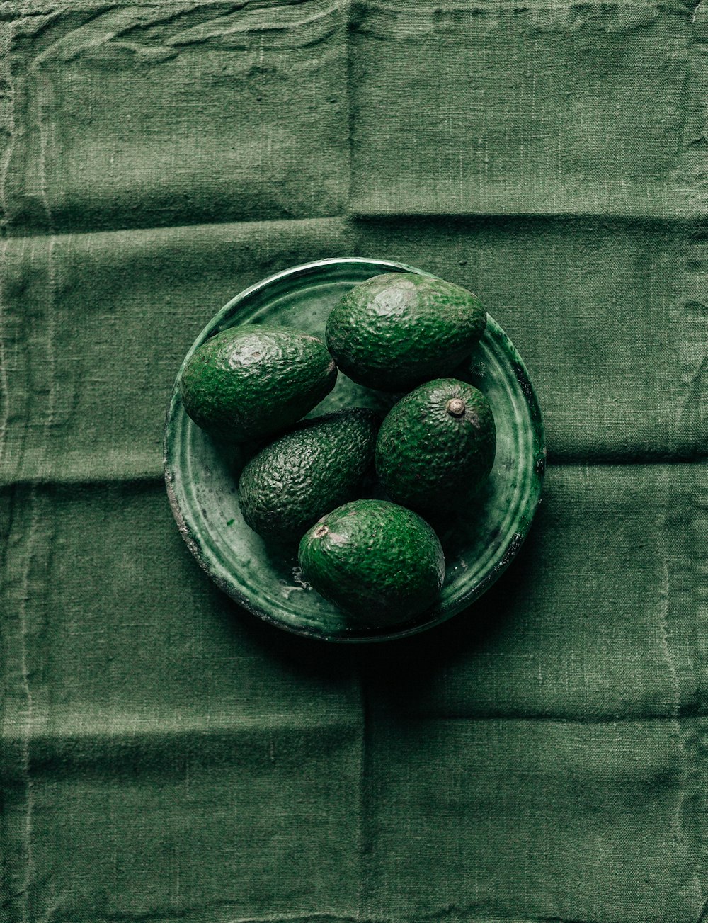 black round fruits in clear glass bowl