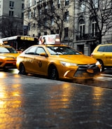 yellow taxi cab on road during daytime