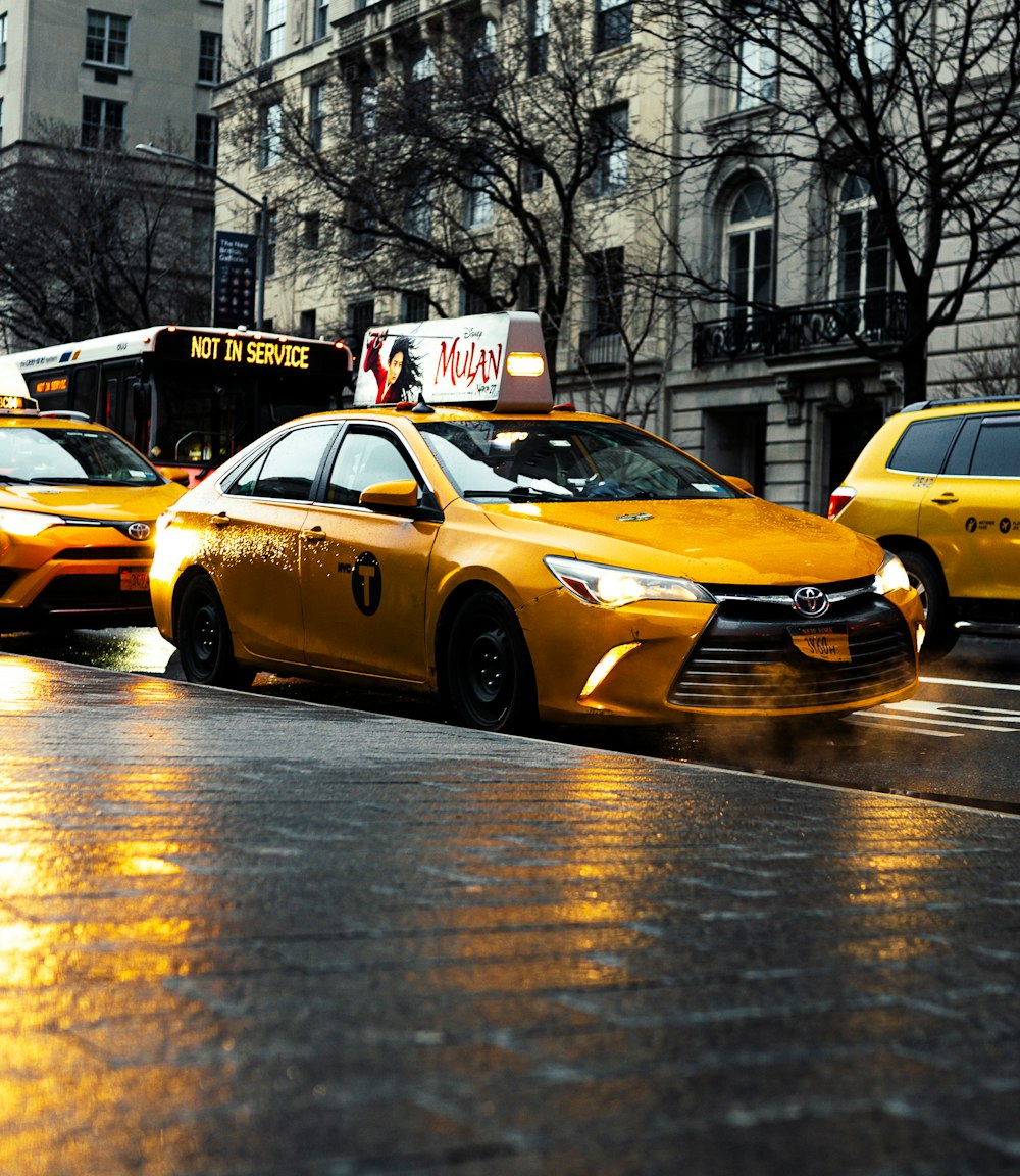 yellow taxi cab on road during daytime