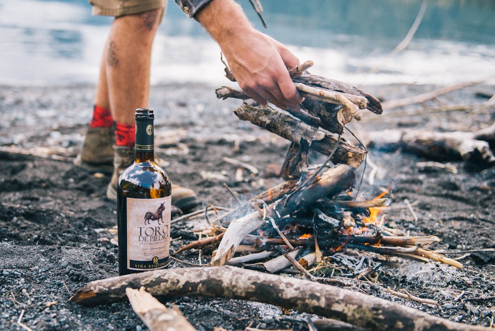 person holding bottle of beer