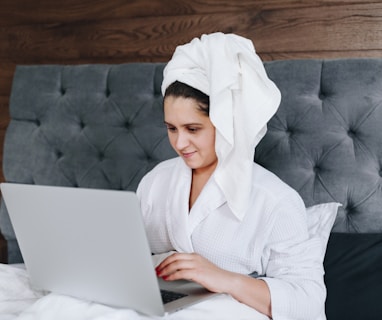 woman in white robe sitting on couch