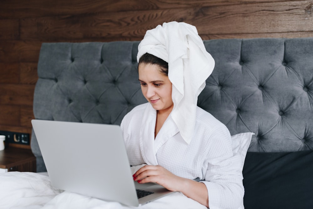 woman in white robe sitting on couch