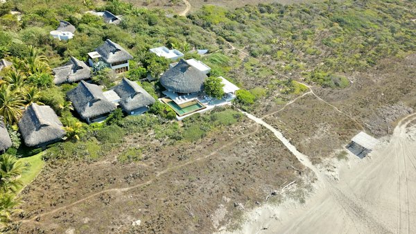 White and gray house on green grass field during daytime — Puerto Escondido, Mexico