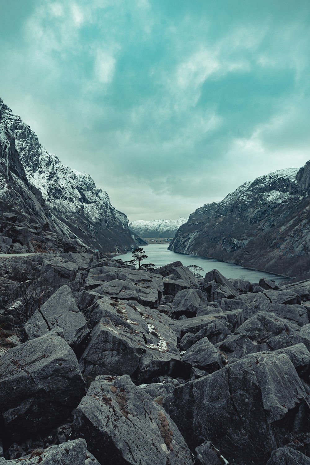 rocky mountain near body of water during daytime