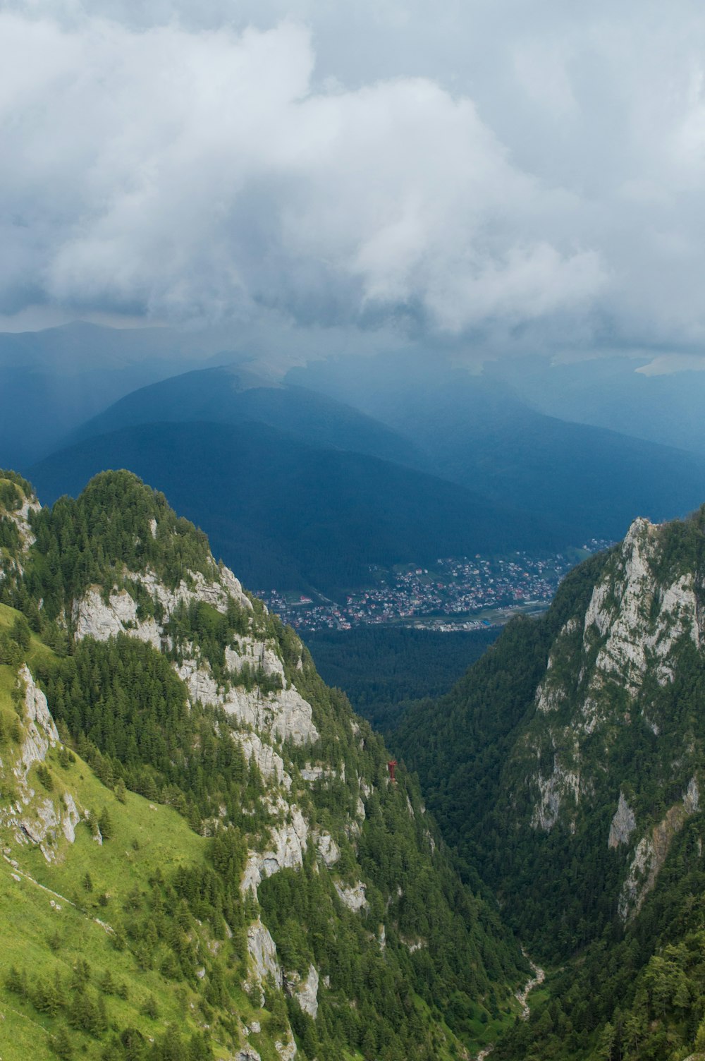 a view of a valley with mountains in the background