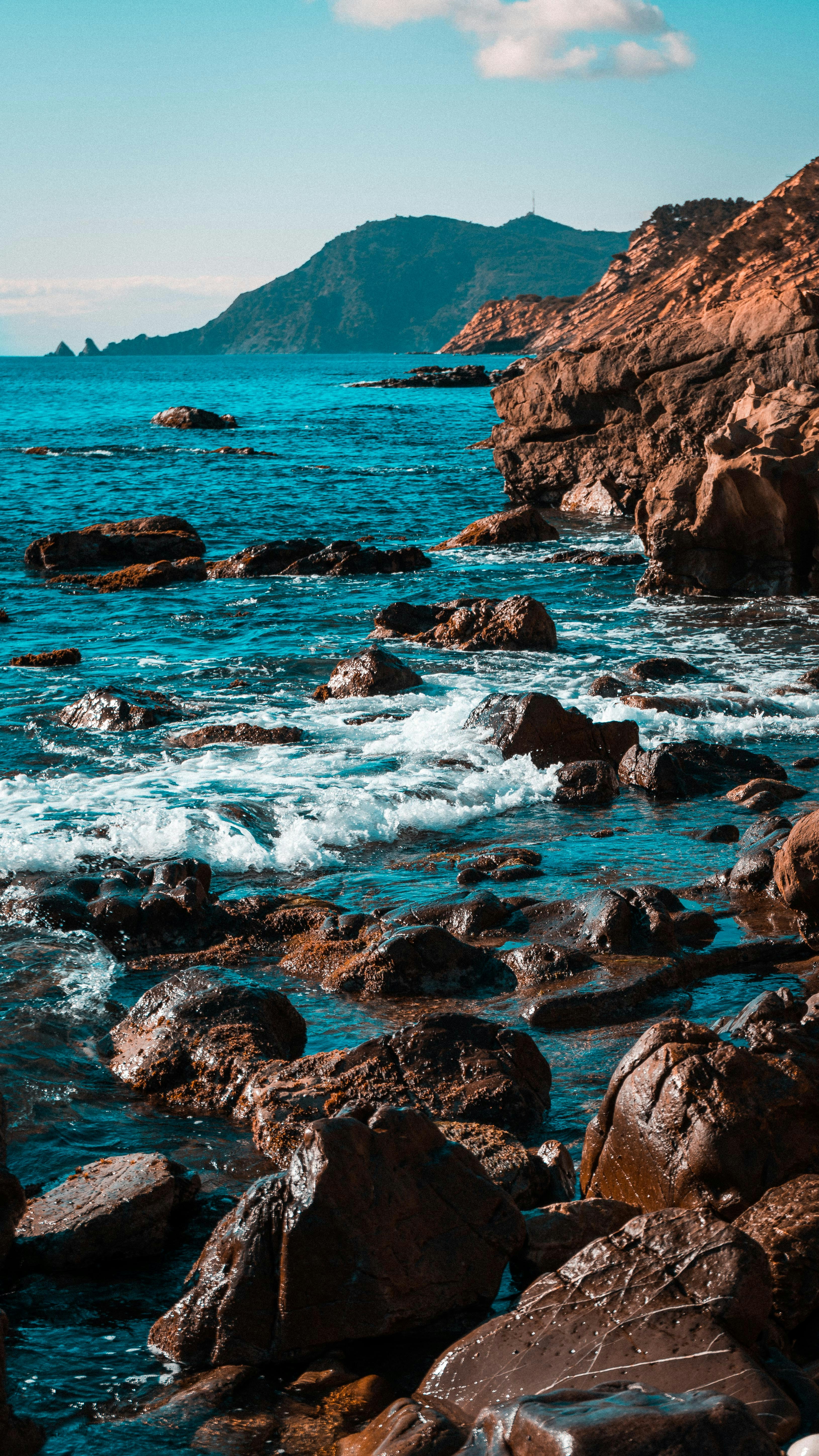 brown rock formation on sea during daytime