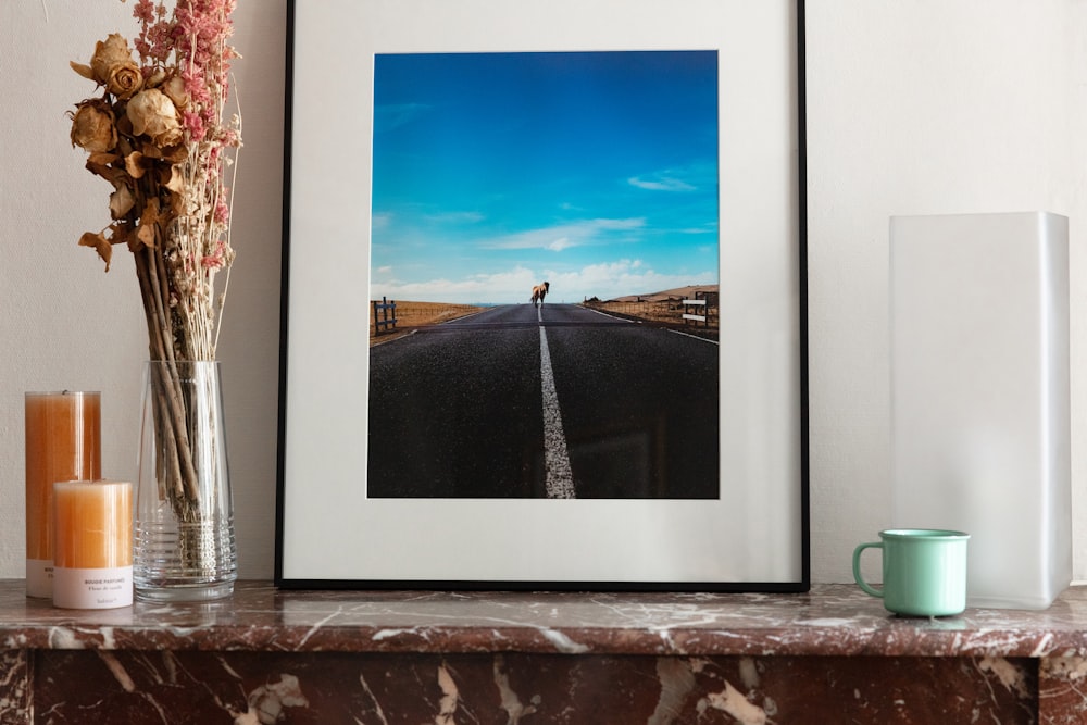 body of water under blue sky and white clouds painting