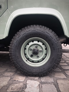 Close-up of the silent omnidirectional wheels smoothly rolling over cobblestone street during a city commute.