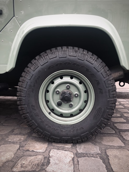 Close-up of the silent omnidirectional wheels smoothly rolling over cobblestone street during a city commute.