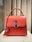 red leather handbag on white table