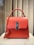 red leather handbag on white table