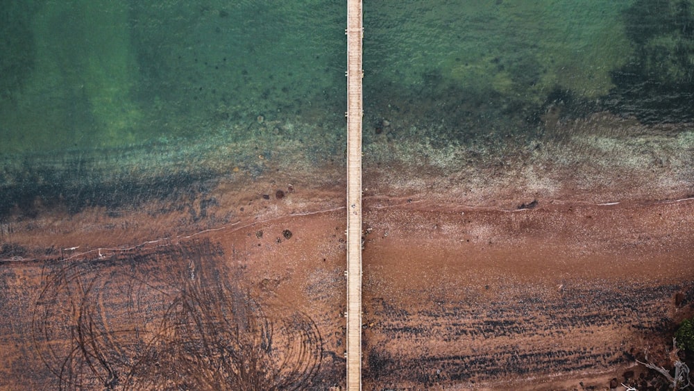 white metal rod on brown sand