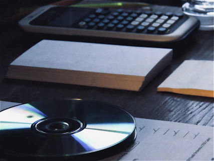 Financial documents and calculator on a wooden desk