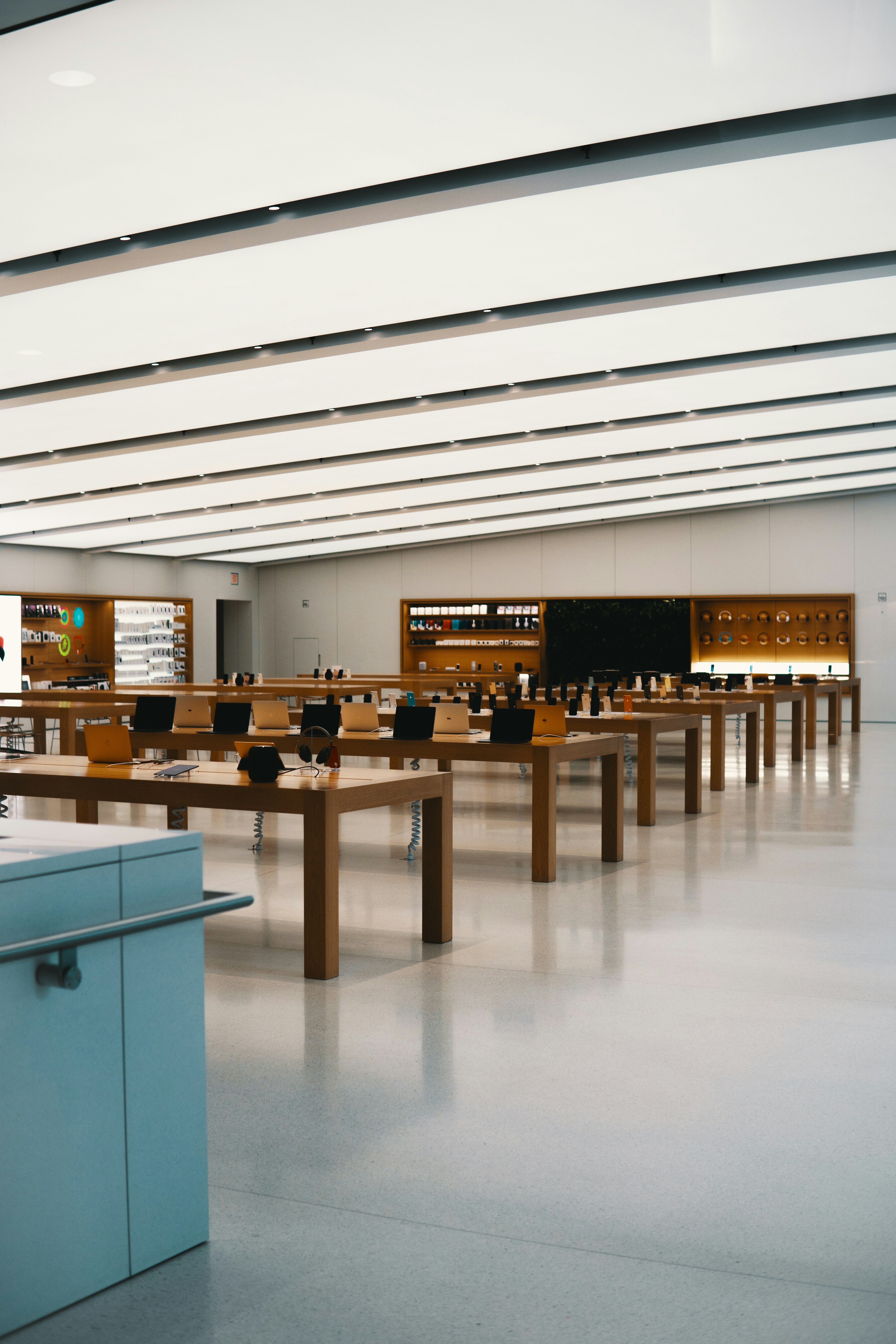 Refurbished laptops arranged on display shelf in modern electronics store