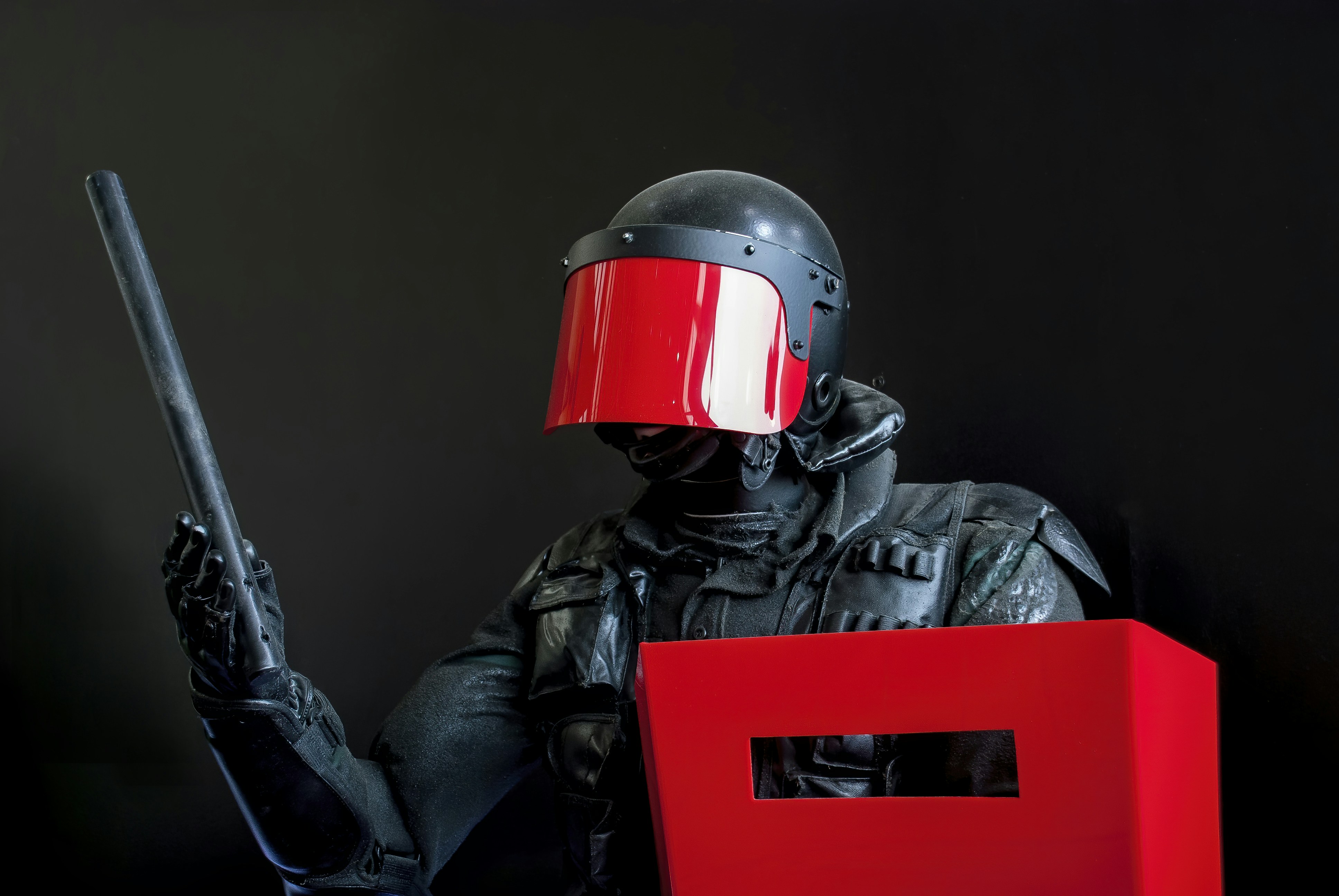 man in black leather jacket wearing red helmet