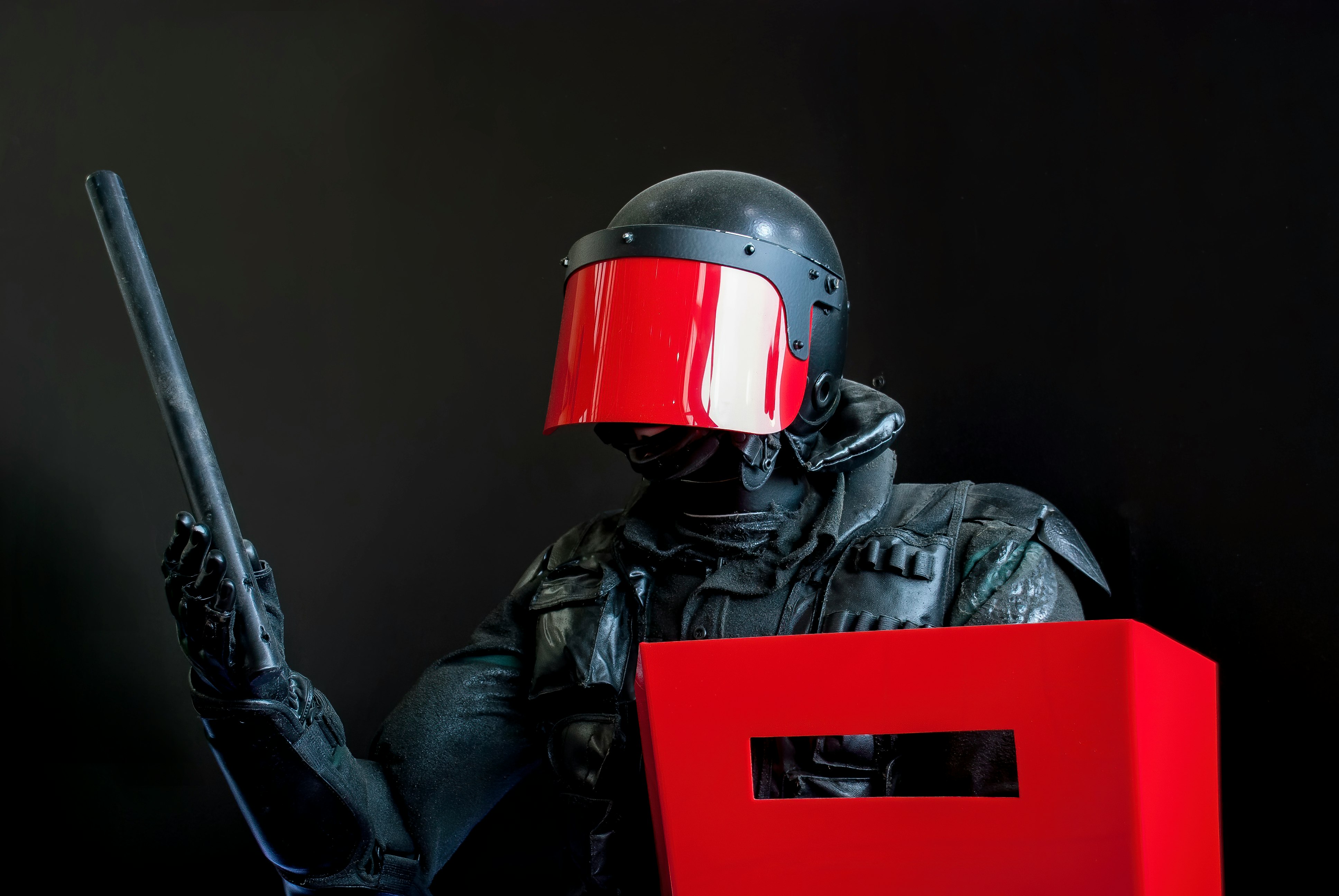 man in black leather jacket wearing red helmet