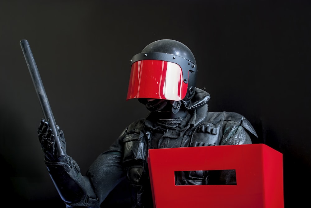 man in black leather jacket wearing red helmet