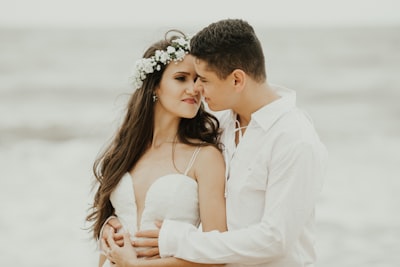 man in white dress shirt kissing woman in white dress bride google meet background