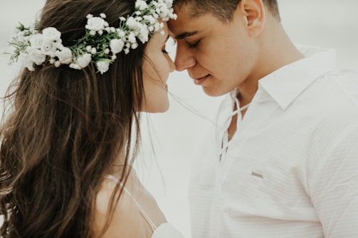 woman in white dress shirt kissing mans cheek