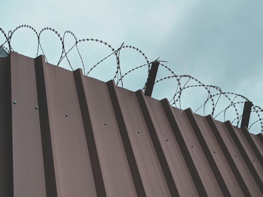 Barbed Wire and metal sheet wall to protect a dangerous construction site.