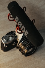 black and silver dslr camera beside black and white UNK