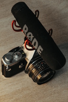 black and silver dslr camera beside black and white UNK