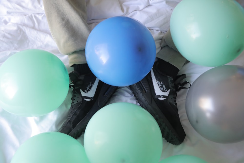blue and green balloons on black and white textile