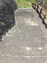Custom steel retaining wall with integrated steps in a backyard.