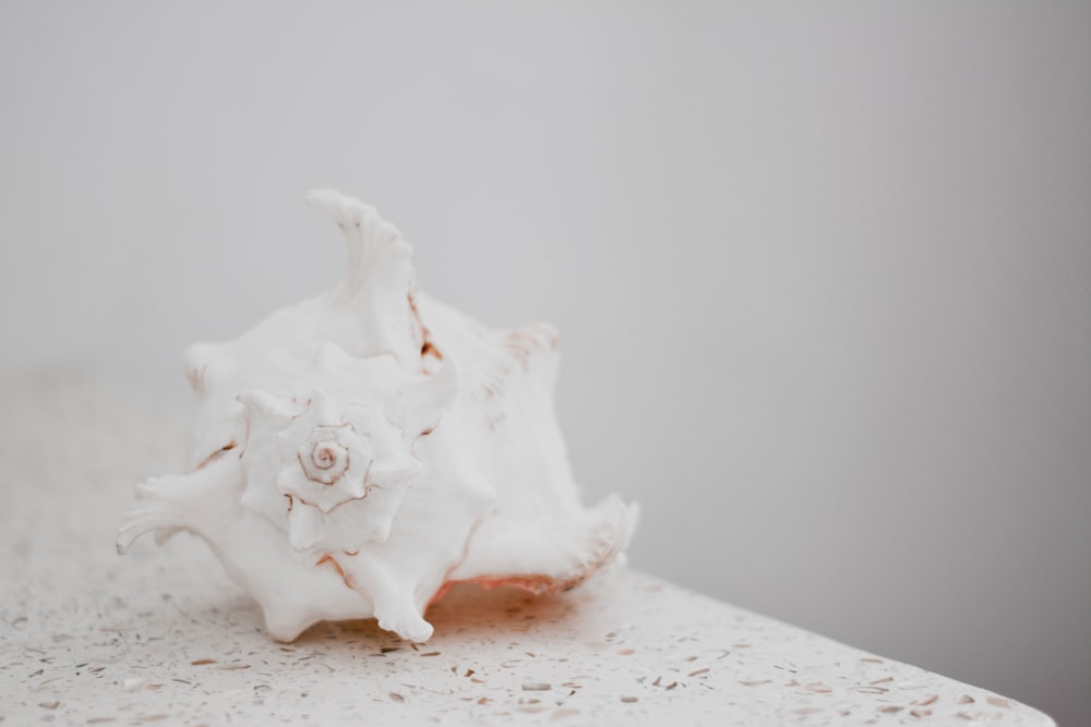 white ceramic figurine on white table