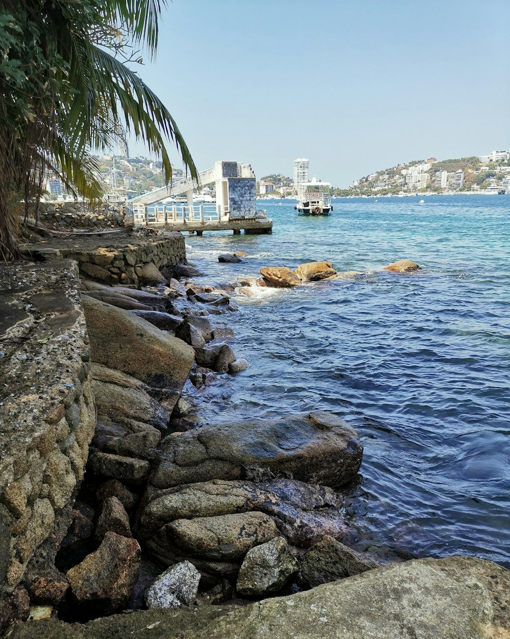 gray rocks near body of water during daytime