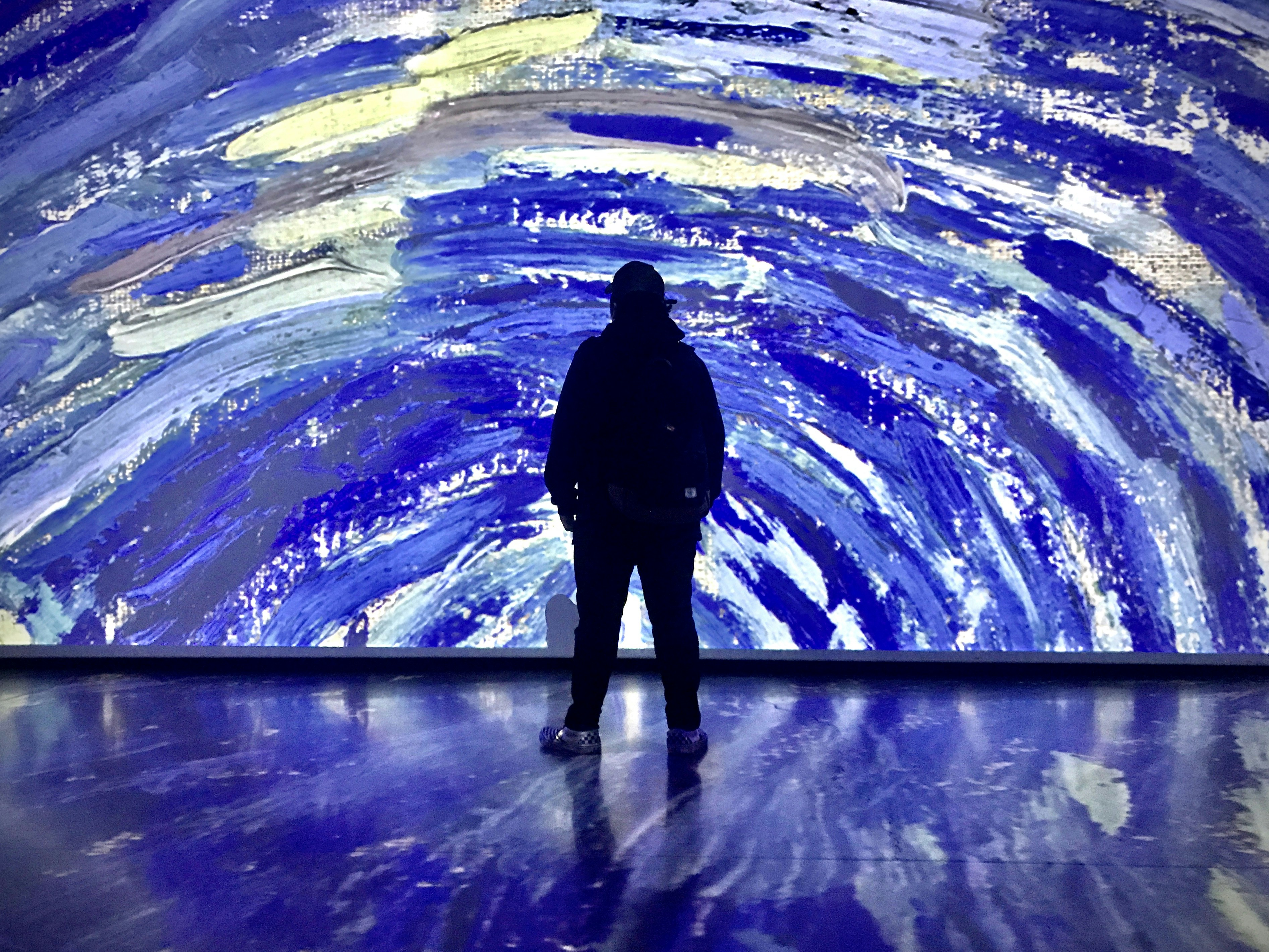 silhouette of man standing on water