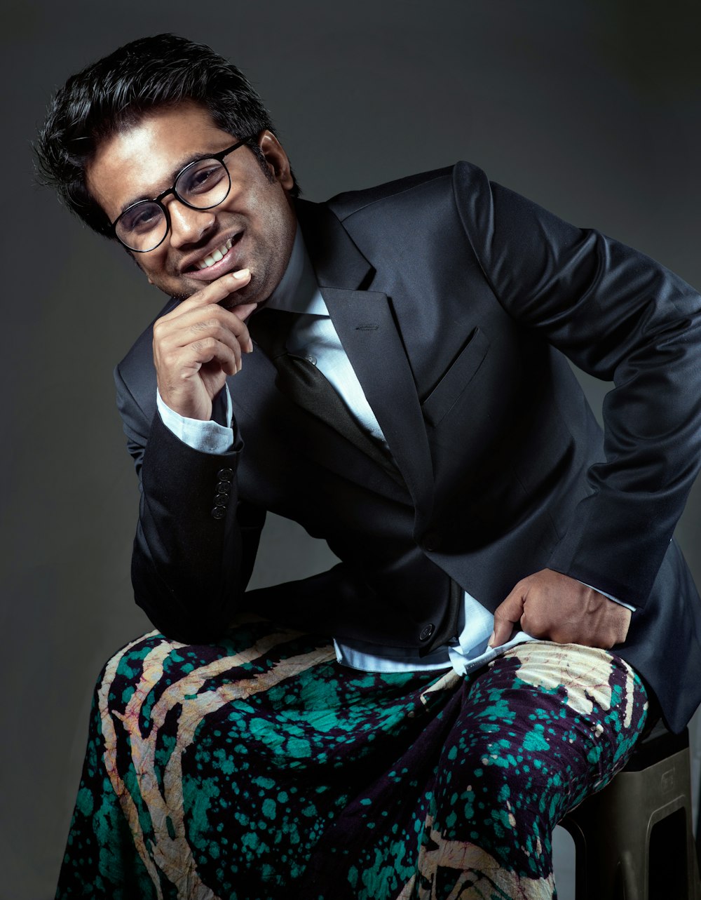 man in black suit jacket sitting on chair