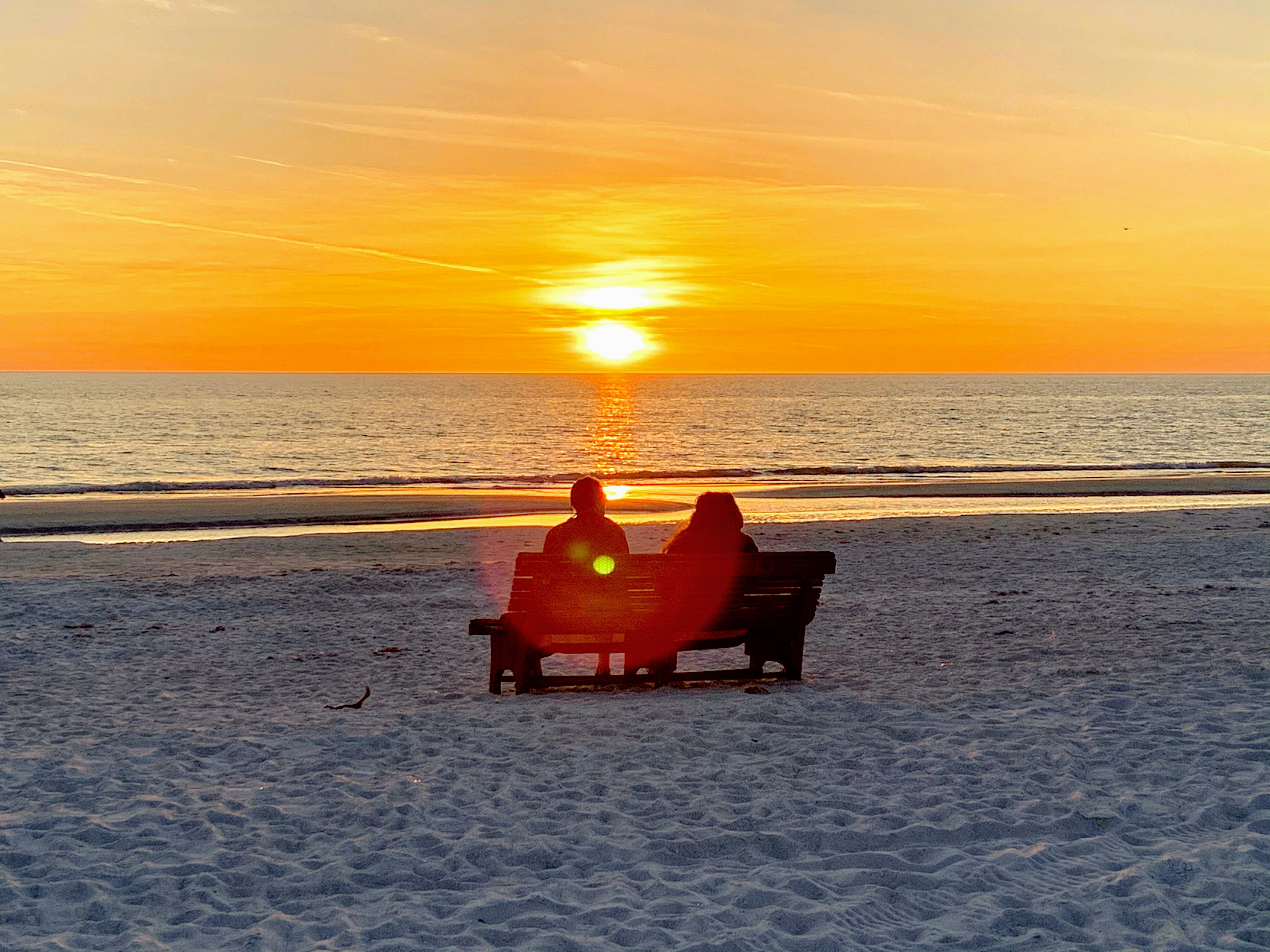 Couple enjoying sunset on a beach getaway