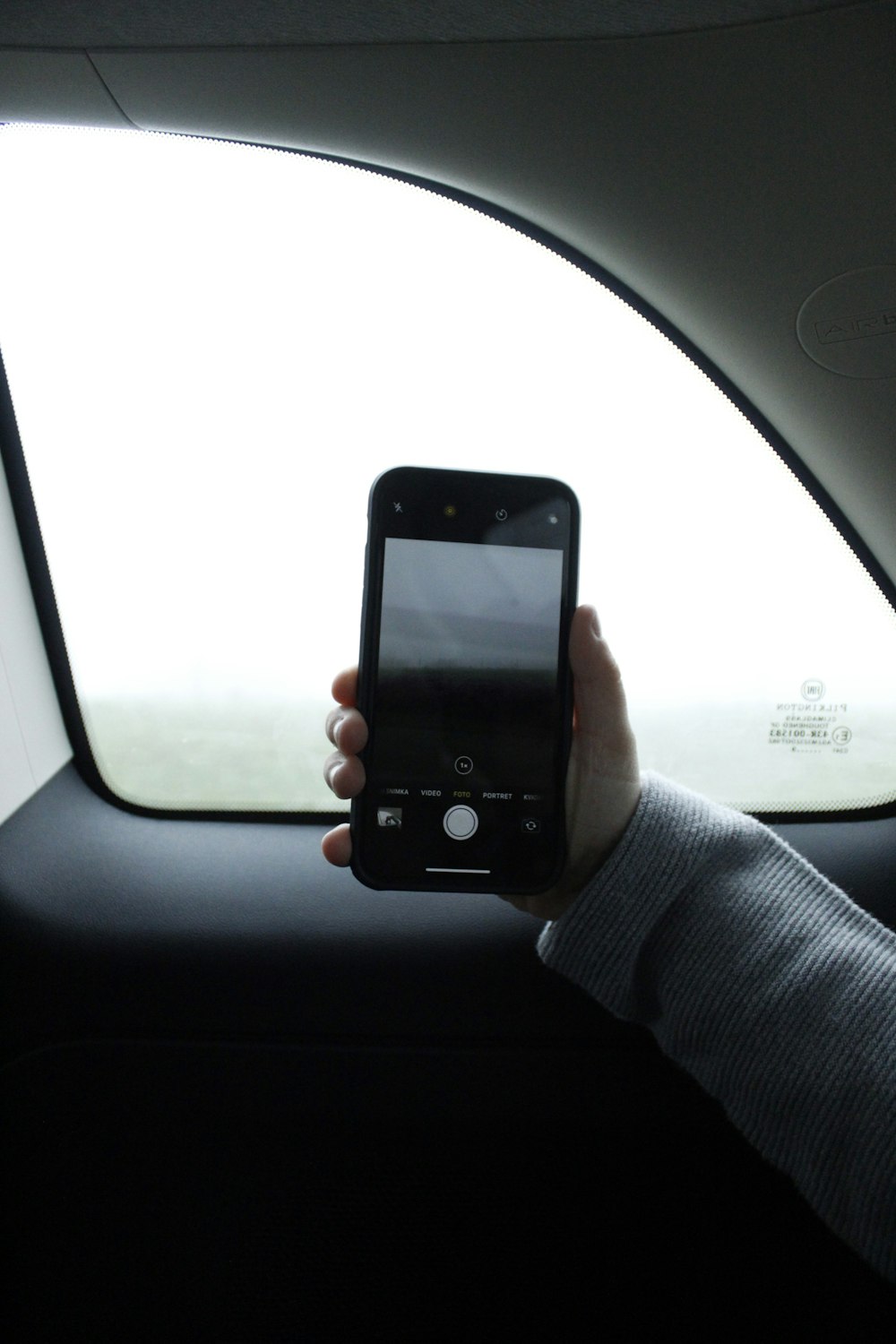 person holding black iphone 4