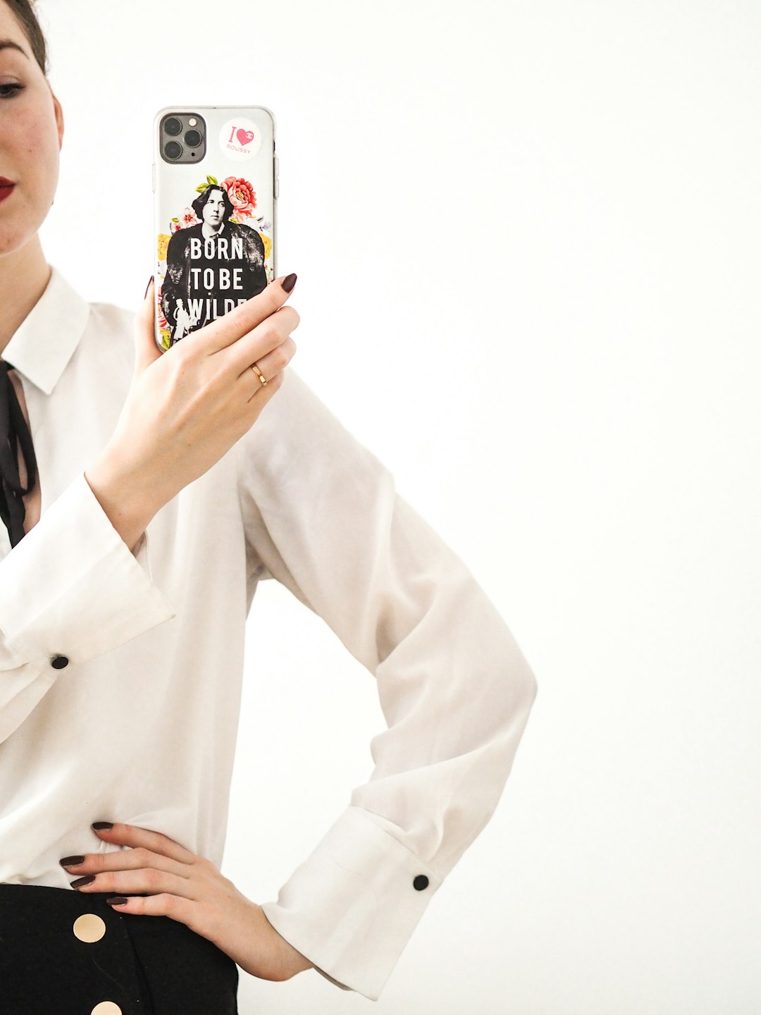 man in white blazer holding black and white ceramic mug