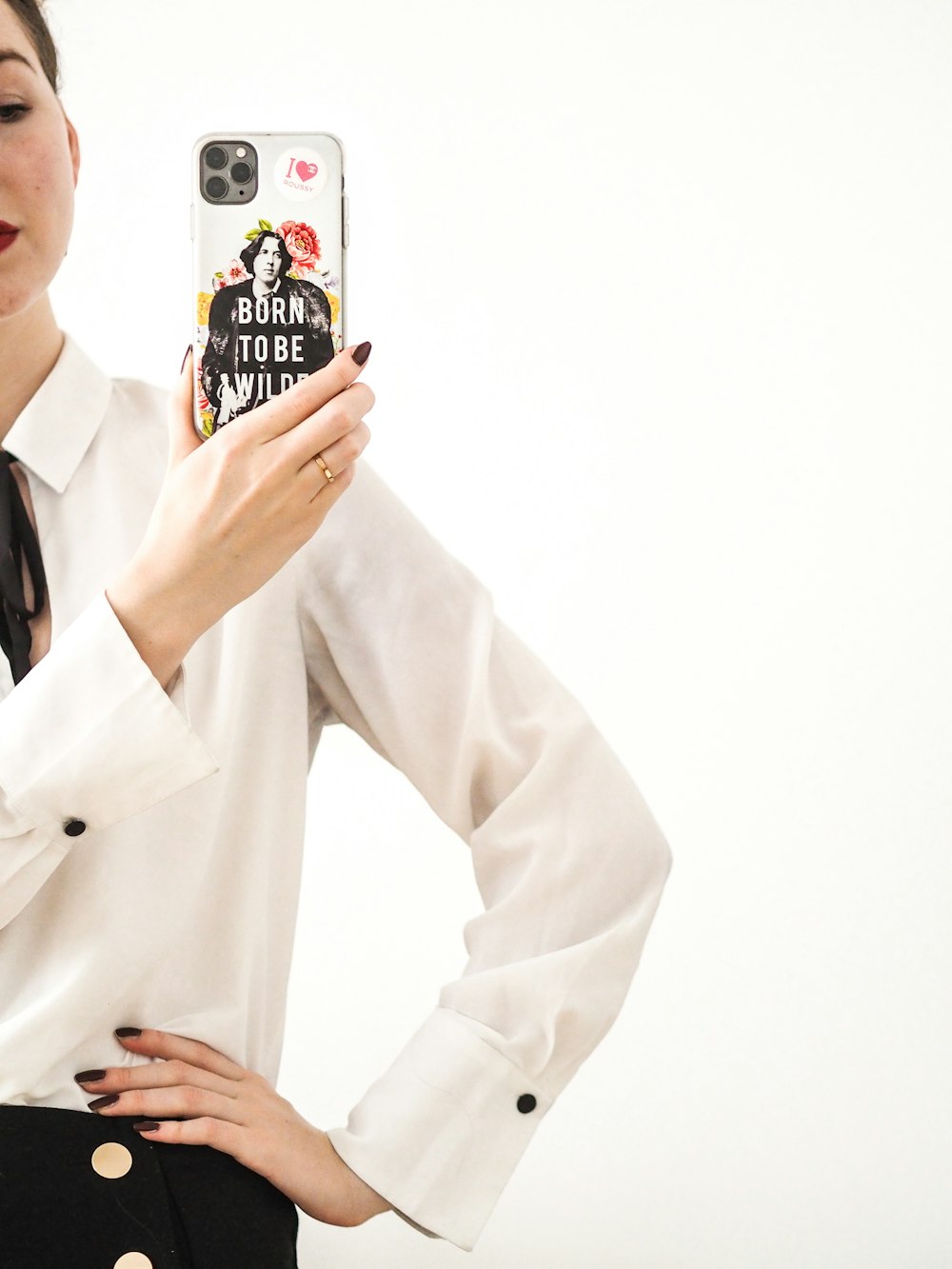 man in white blazer holding black and white ceramic mug