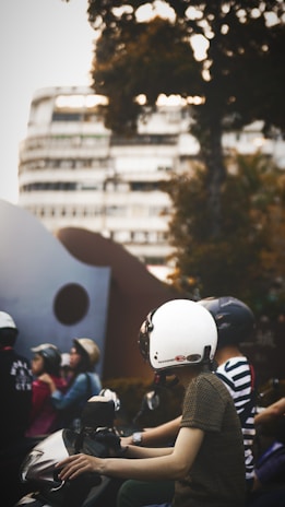 A group of diverse people riding electric scooters together.
