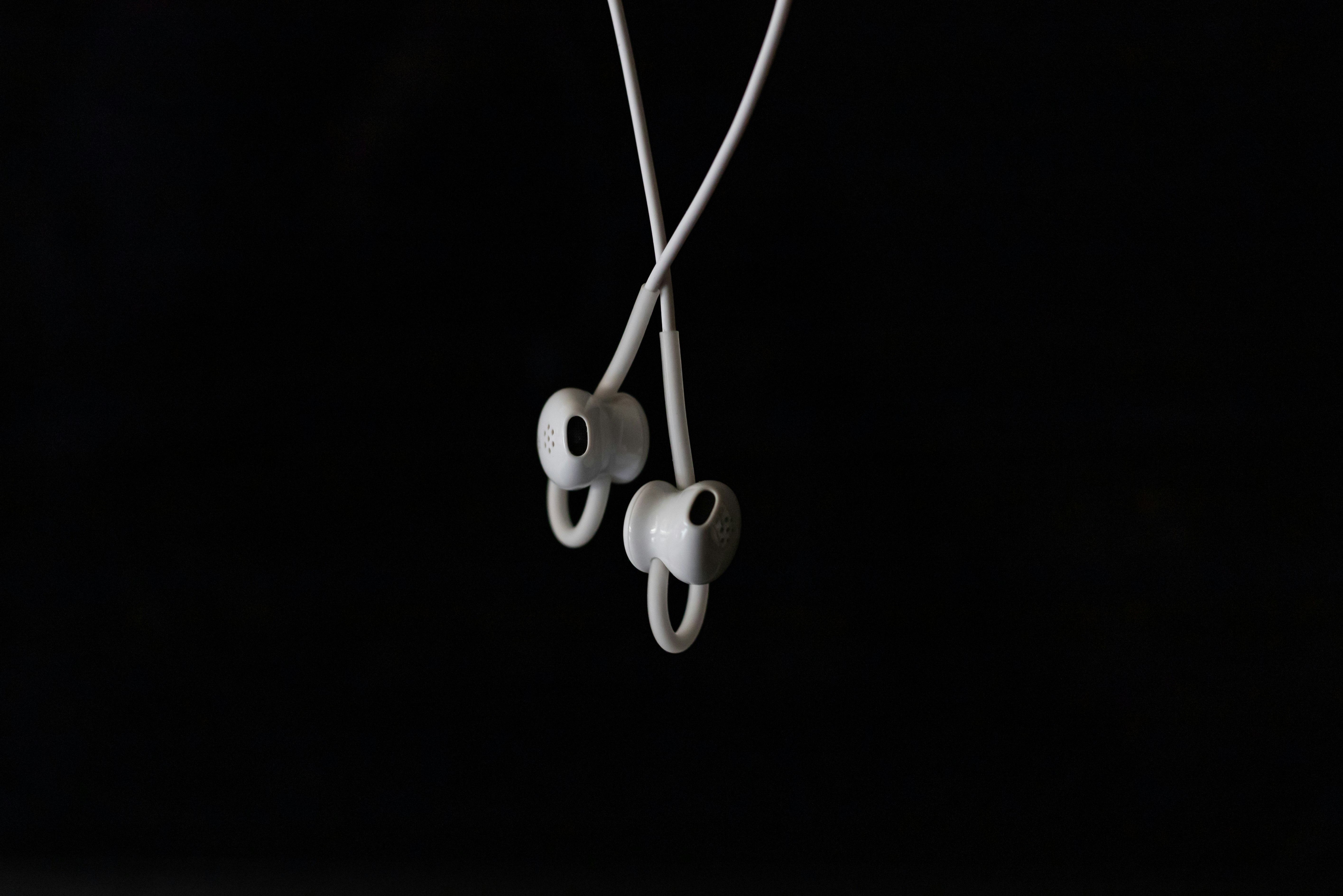 white earbuds on black background