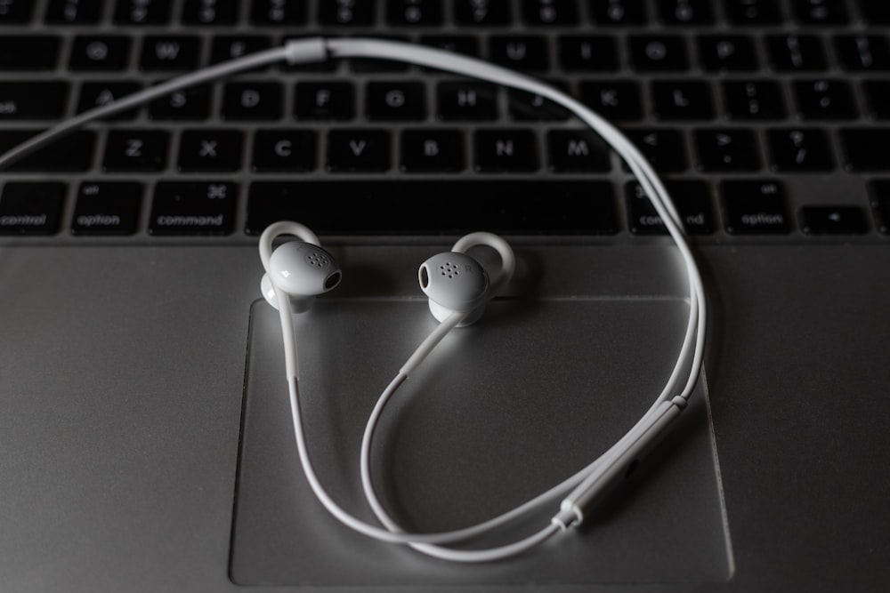 white earbuds on macbook pro