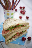 A vibrant lunchbox filled with fresh fruits, veggies, and a sandwich shaped like a star.